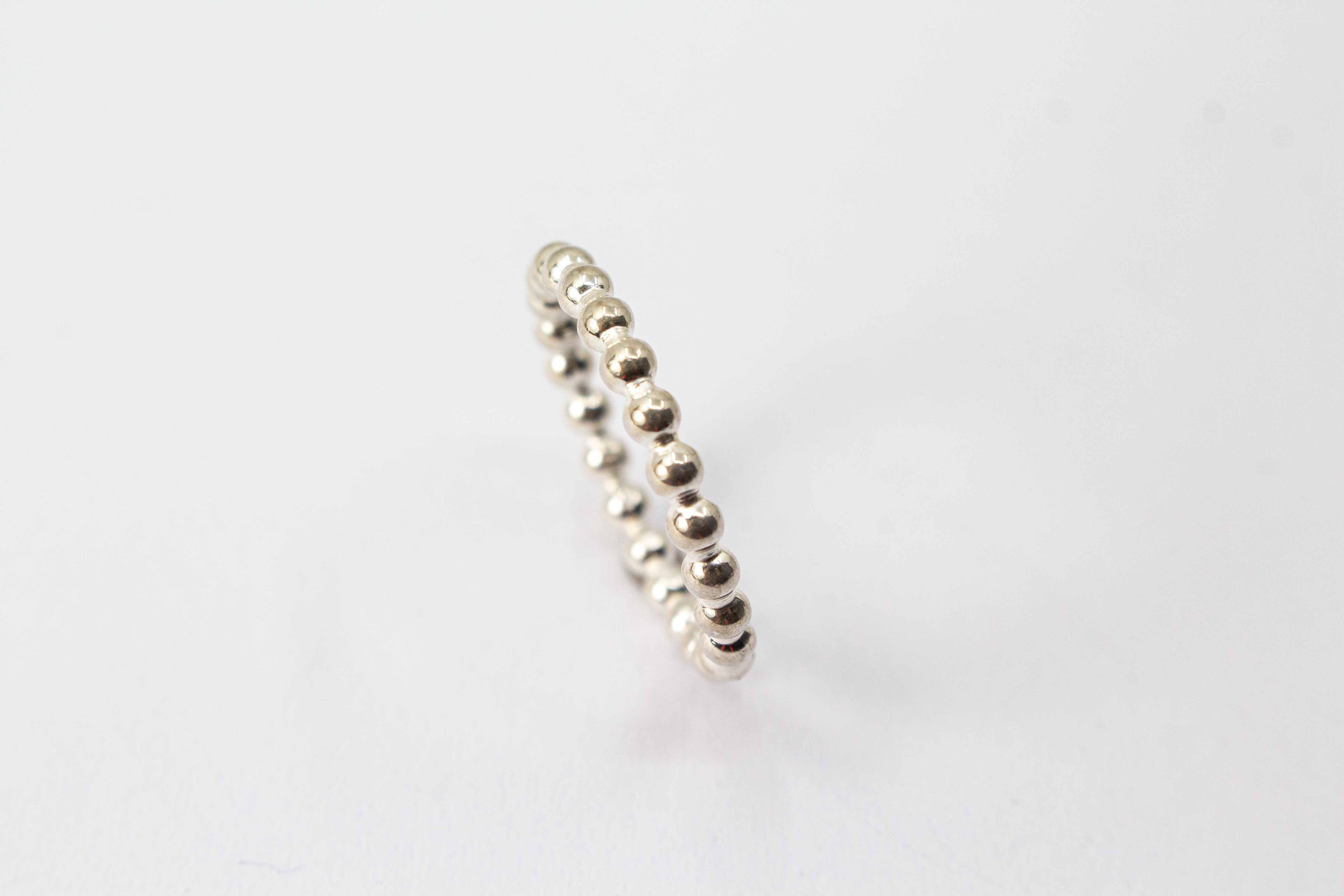 Handgefertigter Kugelring aus glänzendem 925 Sterlingsilber im filigranen Perldraht-Design – minimalistischer Stapelring aus der Goldschmiede Regina Kraus.
