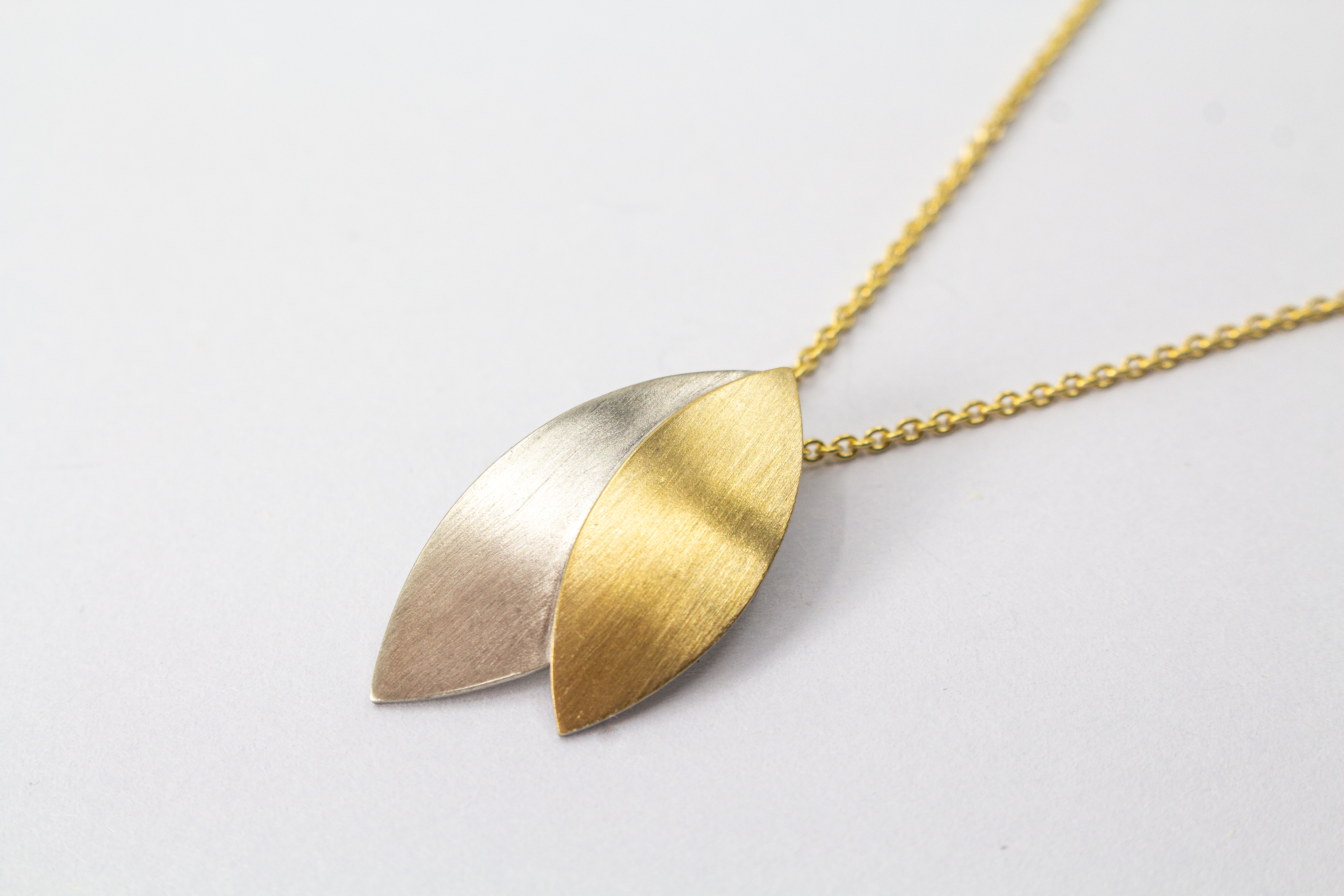 Kette „Blattgold“ aus 925er Sterlingsilber mit Feingoldbelötung und zweifarbigem Anhänger in filigraner Blattform.