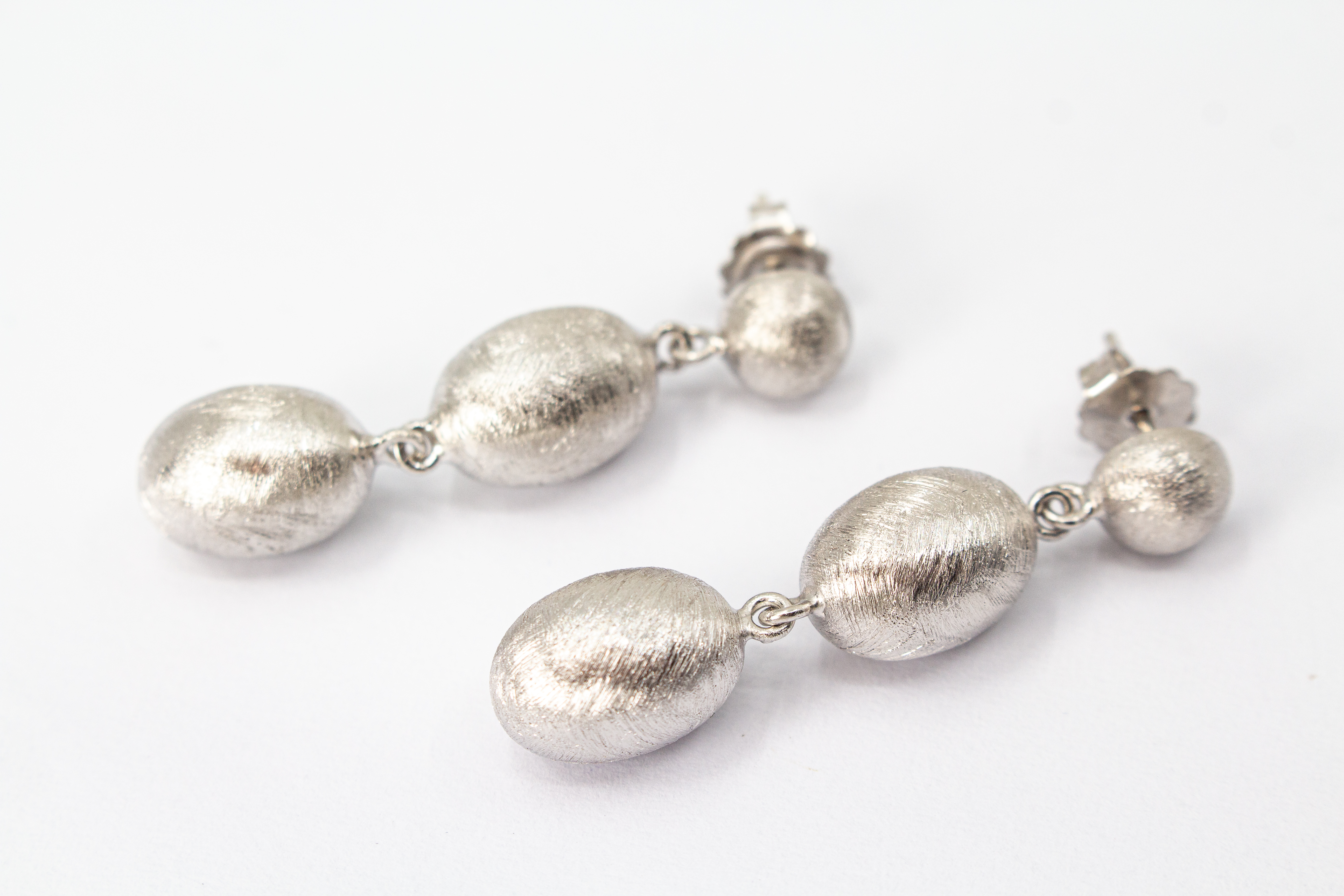 Dreiteilige Design-Ohrhänger aus der italienischen Manufaktur Diva Gioielli, gefertigt aus rhodiniertem 925 Sterling Silber mit fein mattierten, eiförmigen Elementen, erhältlich im Onlineshop der Goldschmiede Regina Kraus.