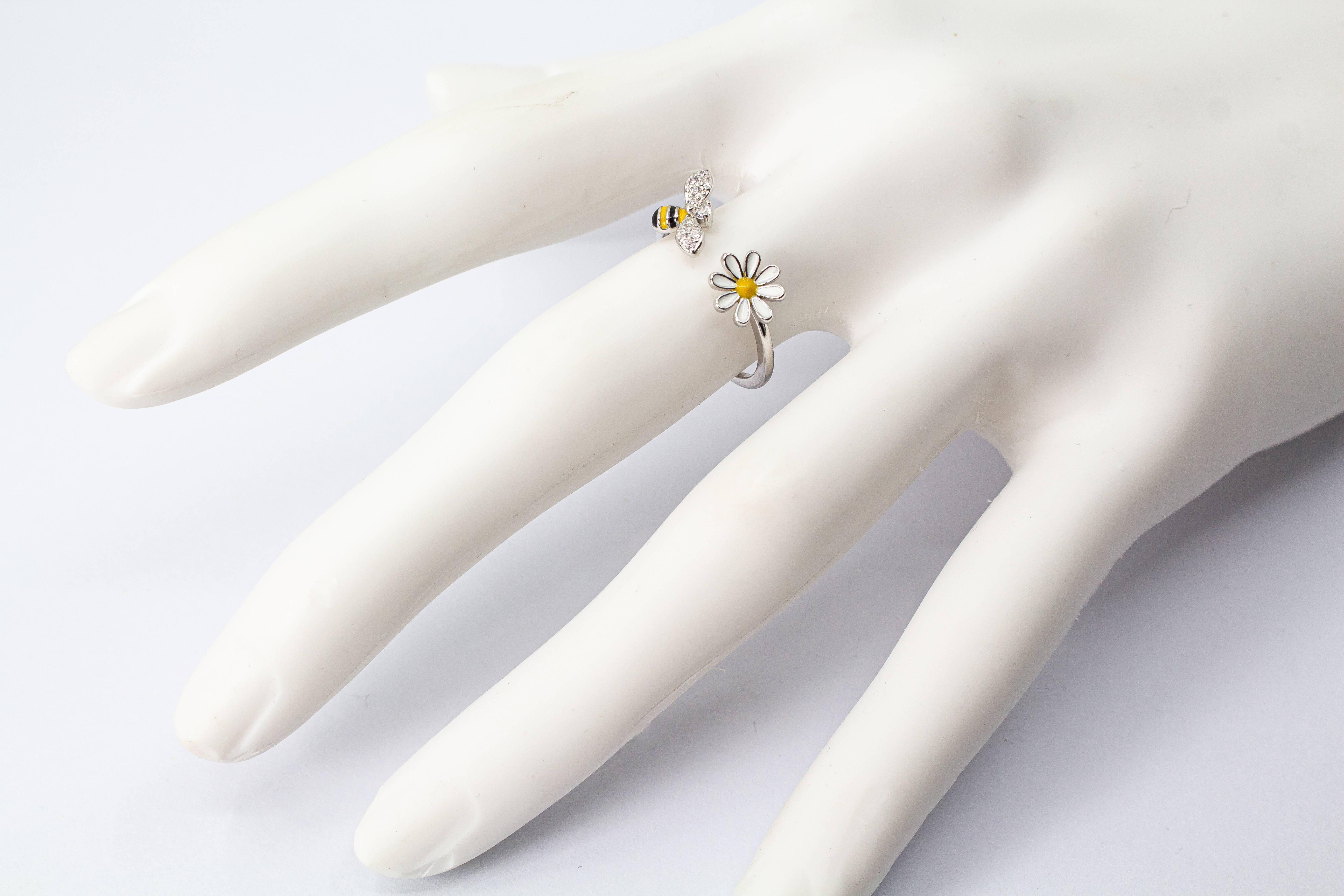 Offener Ring „Blütenbesuch“ aus rhodiniertem 925er Sterlingsilber mit Emaille-Blüte, funkelnder Biene und weißen Zirkonia.