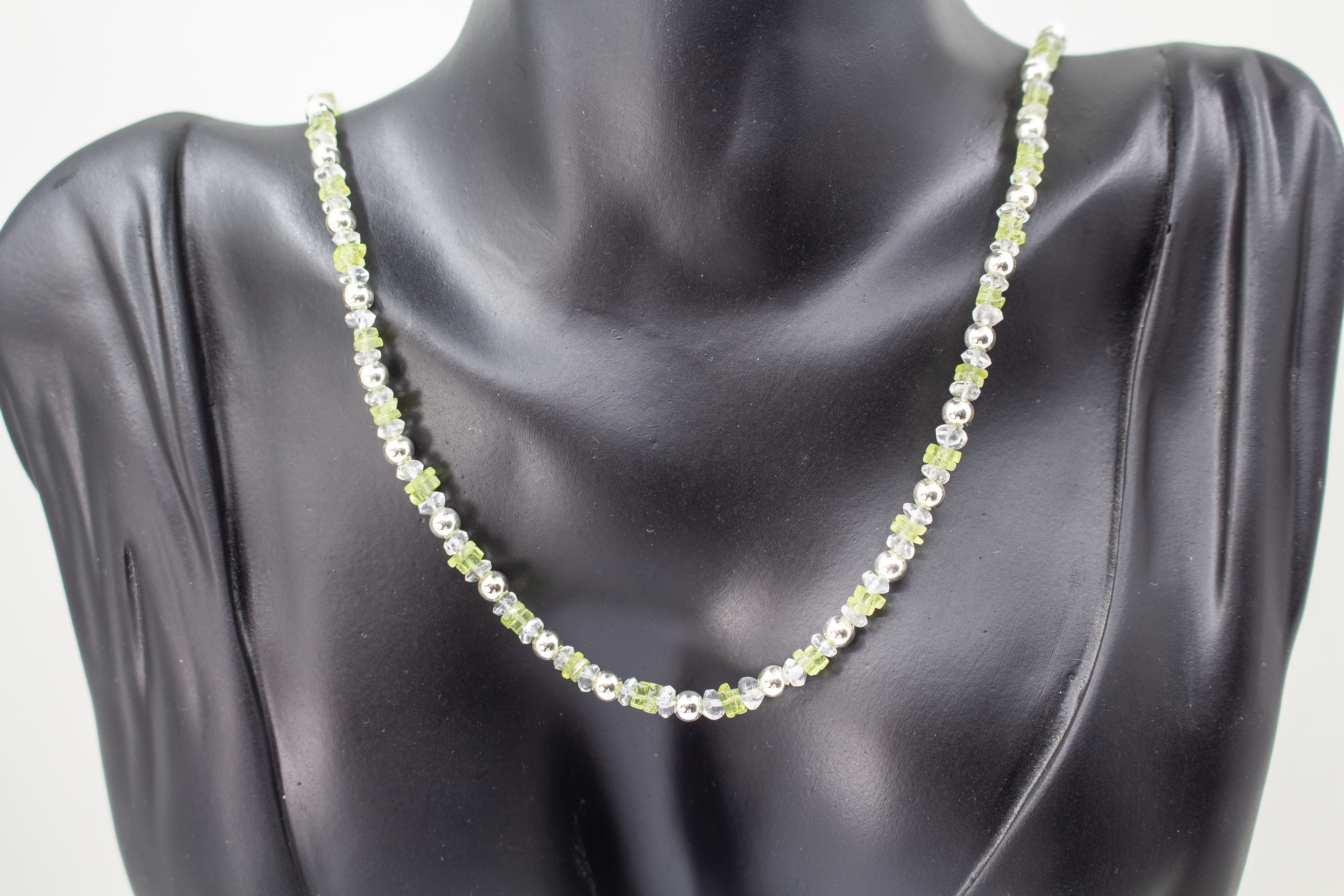 Filigrane Edelsteinhalskette aus hellgrünen Peridot-Splittern, klaren Bergkristall-Elementen und glänzenden 925 Sterling Silberkugeln aus dem Online-Shop der Goldschmiede Regina Kraus