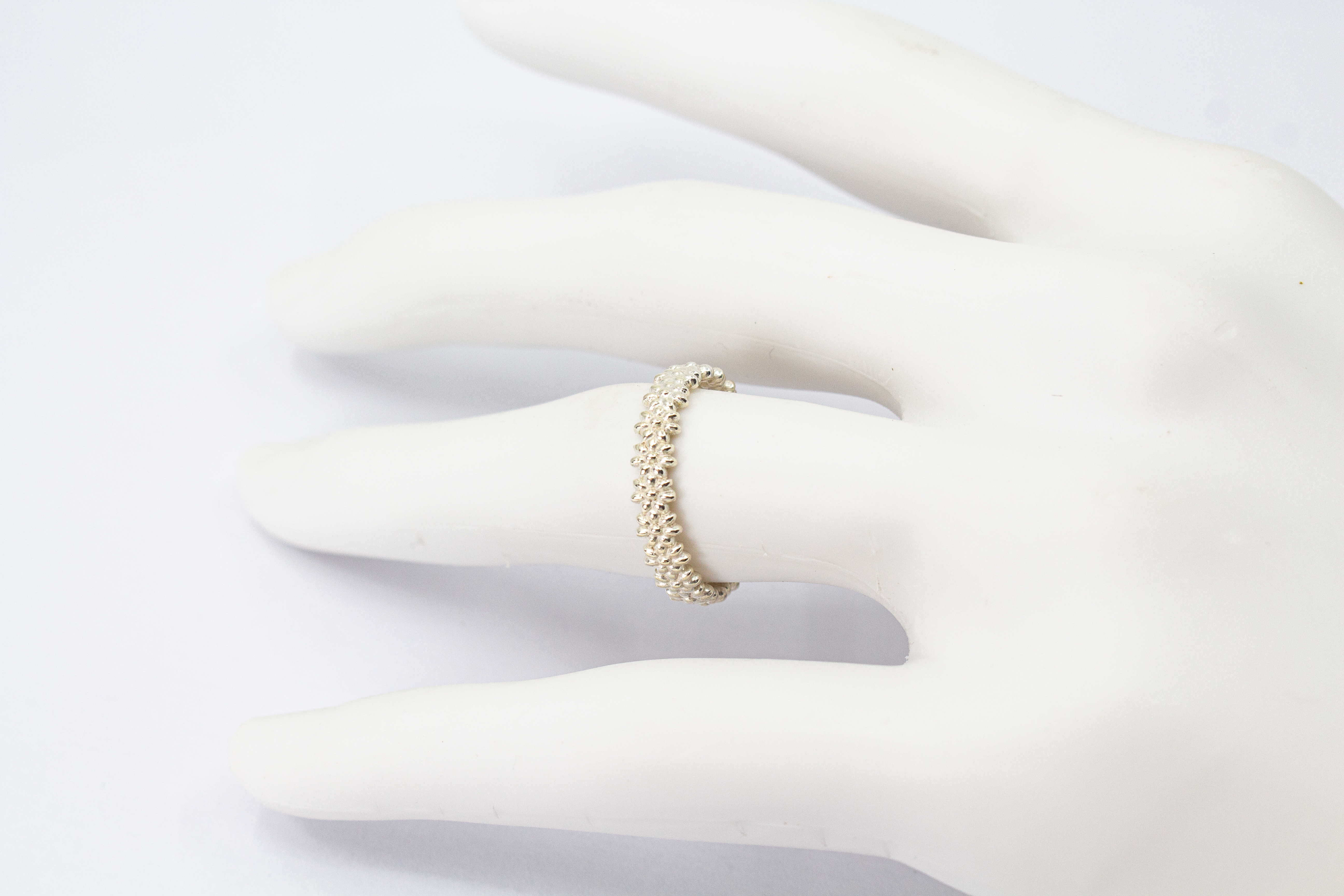 Schmaler, filigraner Ring aus 925 Sterling Silber mit einem rundherum verlaufenden, detaillierten Blütenmuster von der Goldschmiede Regina Kraus