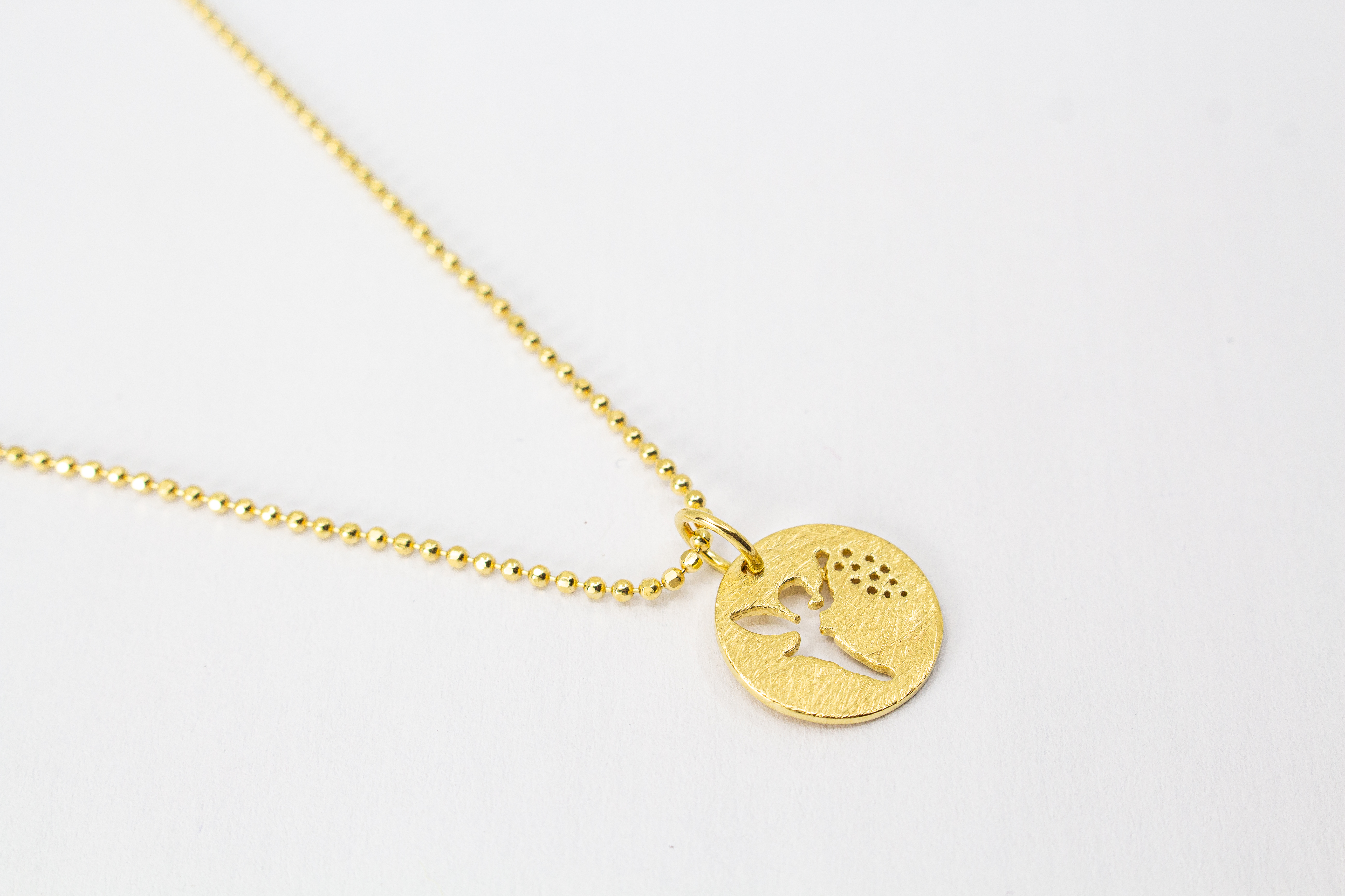 Goldene Kugelkette aus 20 Mikron vergoldetem 925er Sterlingsilber mit rundem Plättchen-Anhänger „Feenstaub“, der eine ausgestanzte Fee zeigt, aus dem Onlineshop der Goldschmiede Regina Kraus.