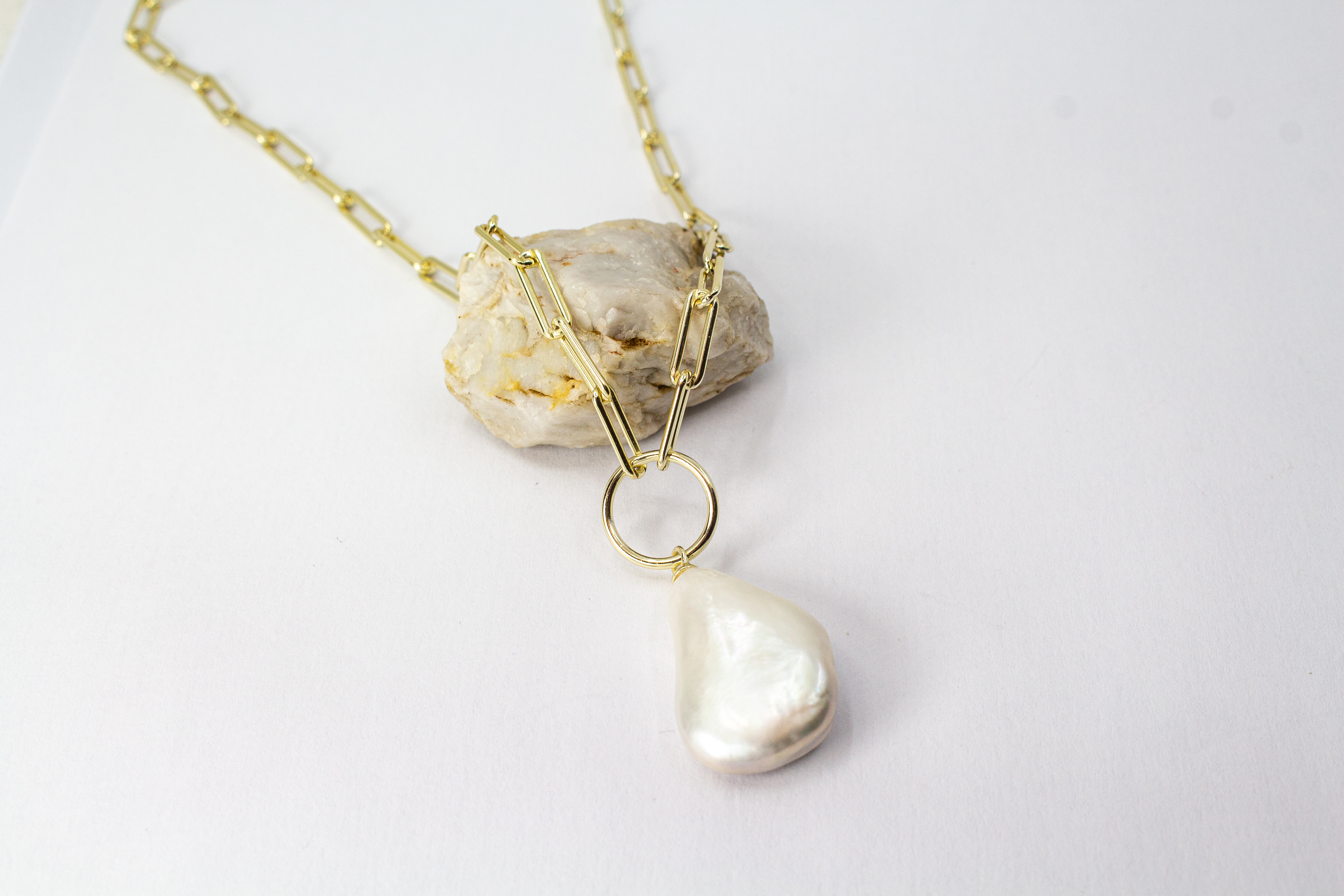 Eine filigrane, hochwertig gelbvergoldete Halskette aus 925er Sterlingsilber von der Goldschmiede Regina Kraus. Als Anhänger dient eine edle, weiße Barock-Zuchtperle mit ihrer typischen, unregelmäßig gewachsenen Form und einem intensiv schimmernden Lüster