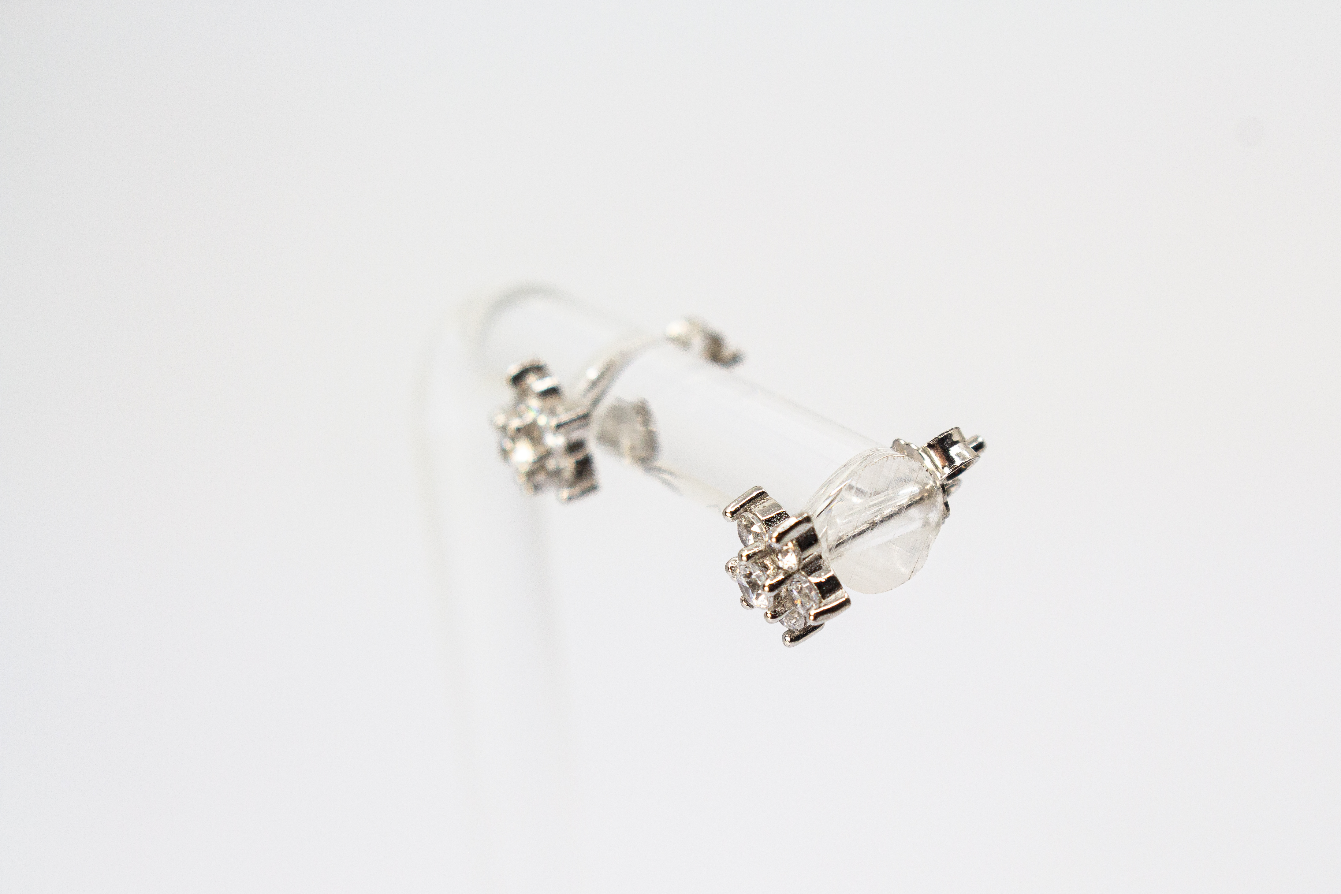 Filigrane Blumen-Ohrstecker aus rhodiniertem 925er Silber in Form einer kleinen Blüte mit funkelndem Zirkonia-Besatz im Onlineshop von Goldschmiede Regina Kraus.