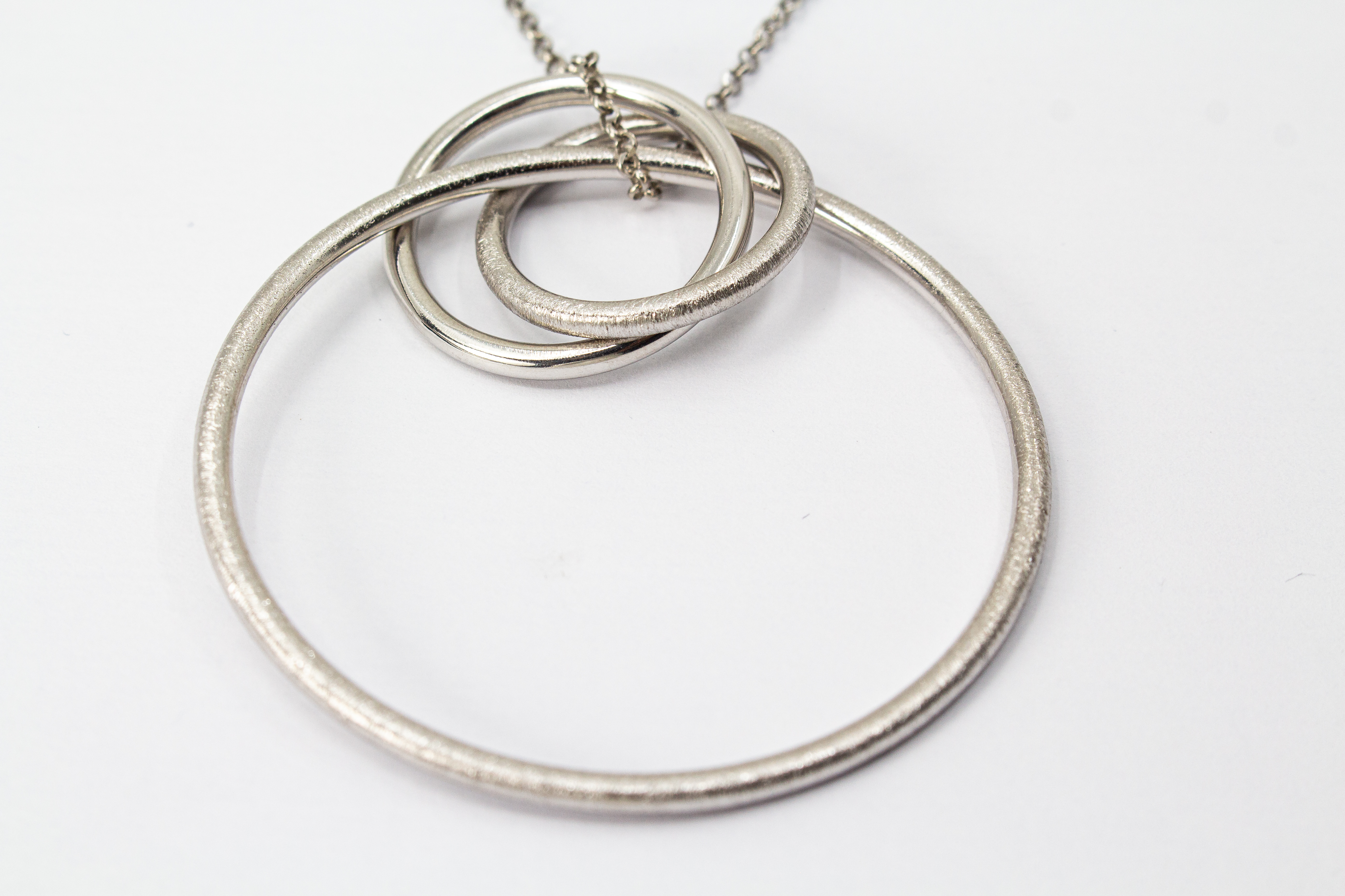 Modernes Collier aus rhodiniertem 925er Sterlingsilber von Diva Gioielli mit einem Anhänger aus mehreren ineinander verschlungenen Ringen in glänzender und eismatter Optik