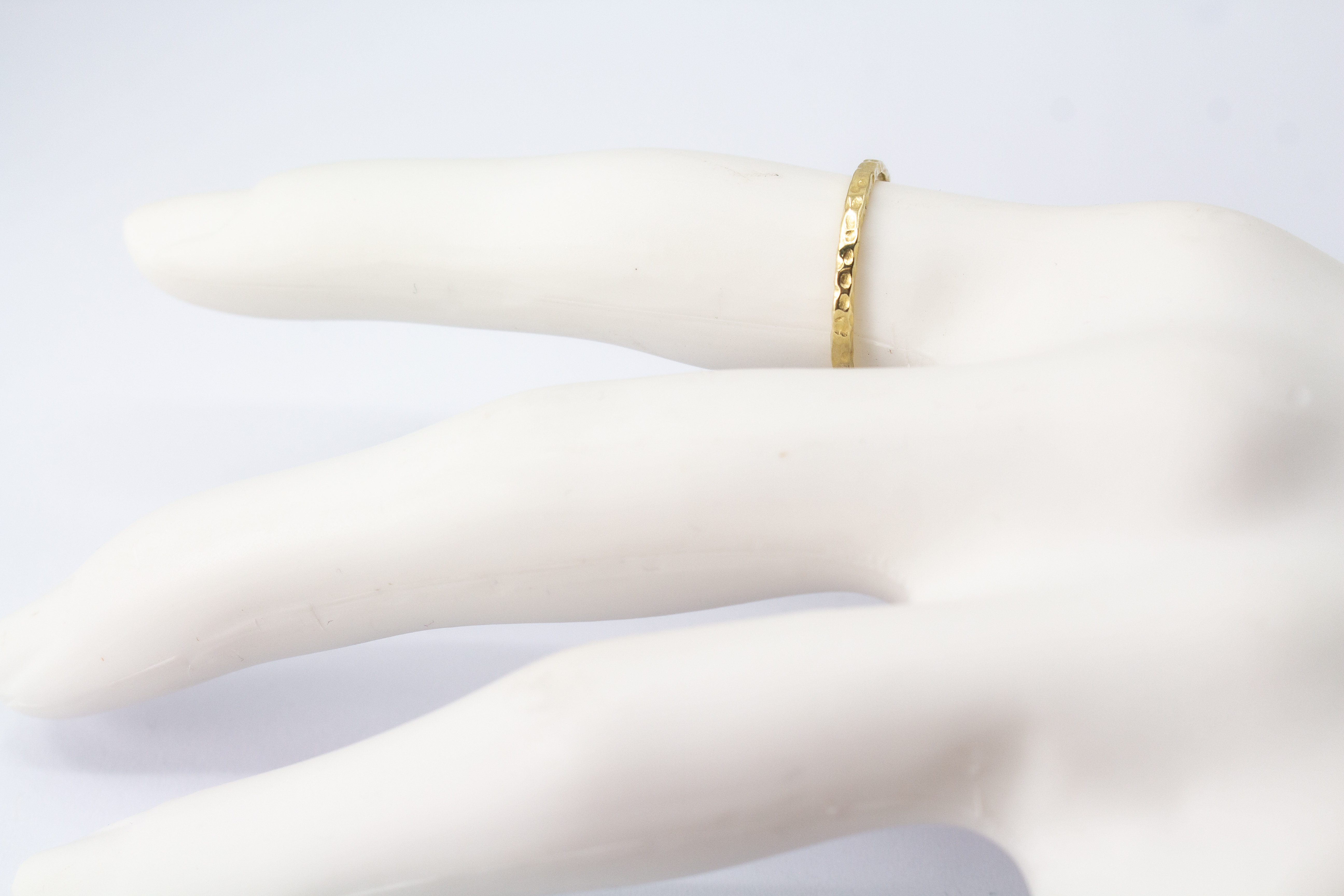 Schmaler, vergoldeter Ring aus 925er Silber mit einer markanten Oberfläche in Hammerschlagoptik im Onlineshop von Goldschmiede Regina Kraus.